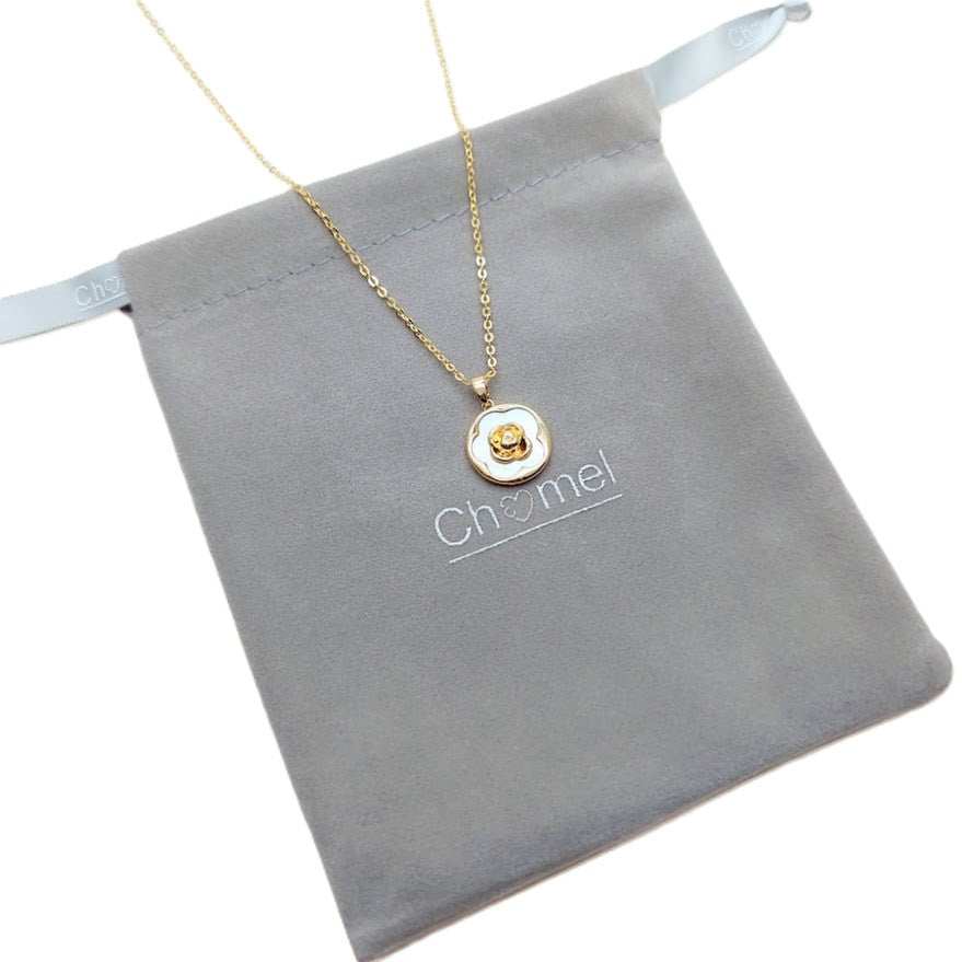 Gold-tone chain necklace with a round white mother-of-pearl pendant and raised gold flower detail; Butterfly Cubic Zirconia keyword included.
