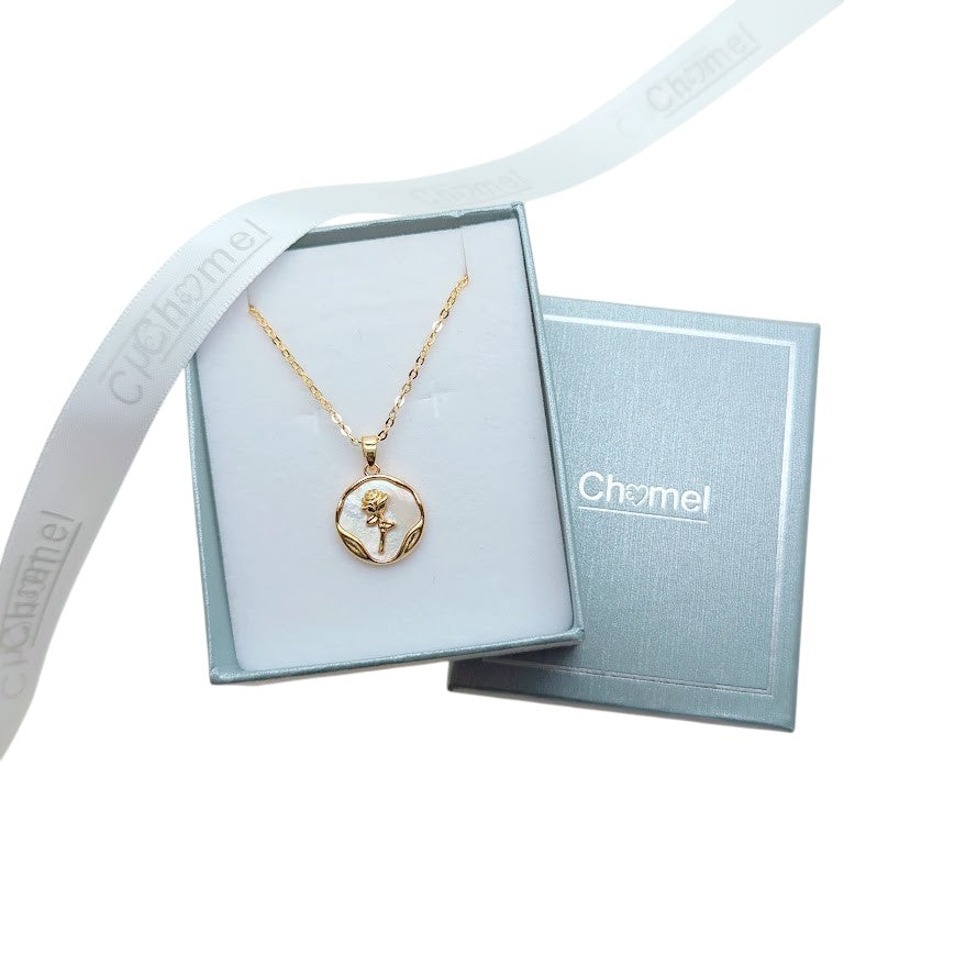 Gold-toned necklace with a round mother-of-pearl pendant, wavy border and flower detail, not Butterfly Cubic Zirconia.
