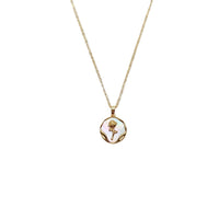 Gold-toned necklace with a round mother-of-pearl pendant, wavy border and flower detail; Butterfly Cubic Zirconia style.