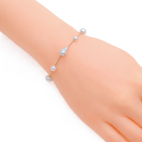 Freshwater Pearl Bracelet featuring small white baroque and round pearls on a delicate silver rhodium plated chain with a spring clasp.