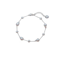 Freshwater Pearl Bracelet featuring irregular baroque and roundish-potato shaped white pearls on a rhodium plated chain with a spring clasp.