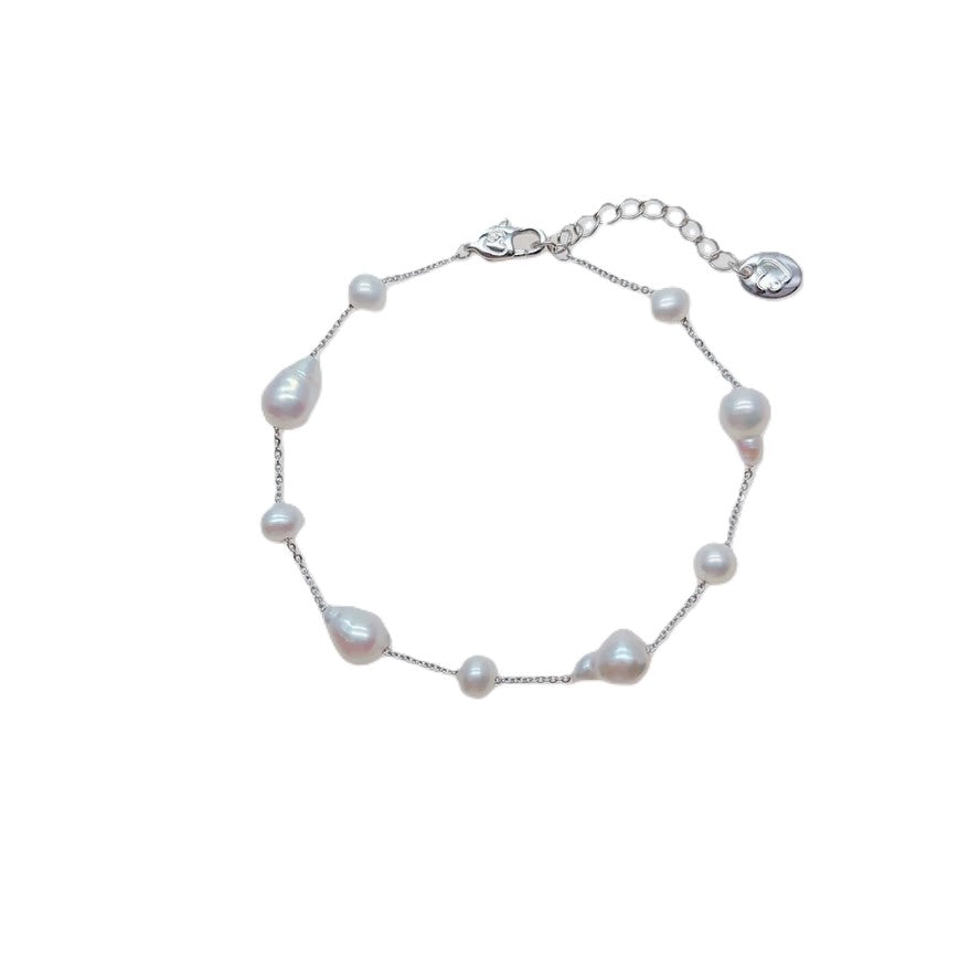 Freshwater Pearl Bracelet featuring irregular baroque and roundish-potato shaped white pearls on a rhodium plated chain with a spring clasp.
