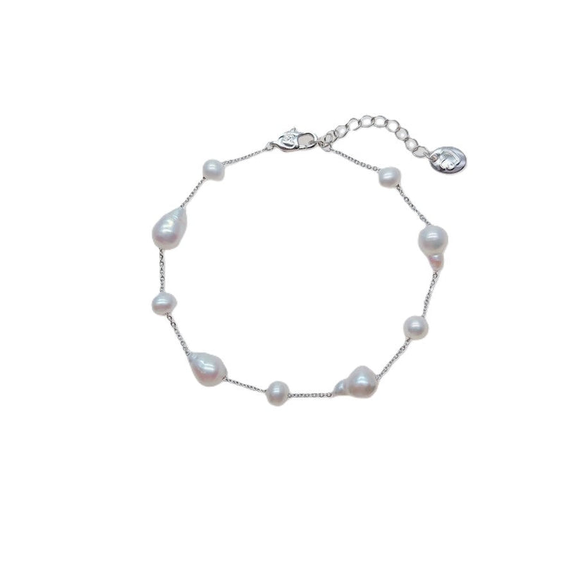 Freshwater Pearl Bracelet featuring irregular baroque and roundish-potato shaped white pearls on a rhodium plated chain with a spring clasp.