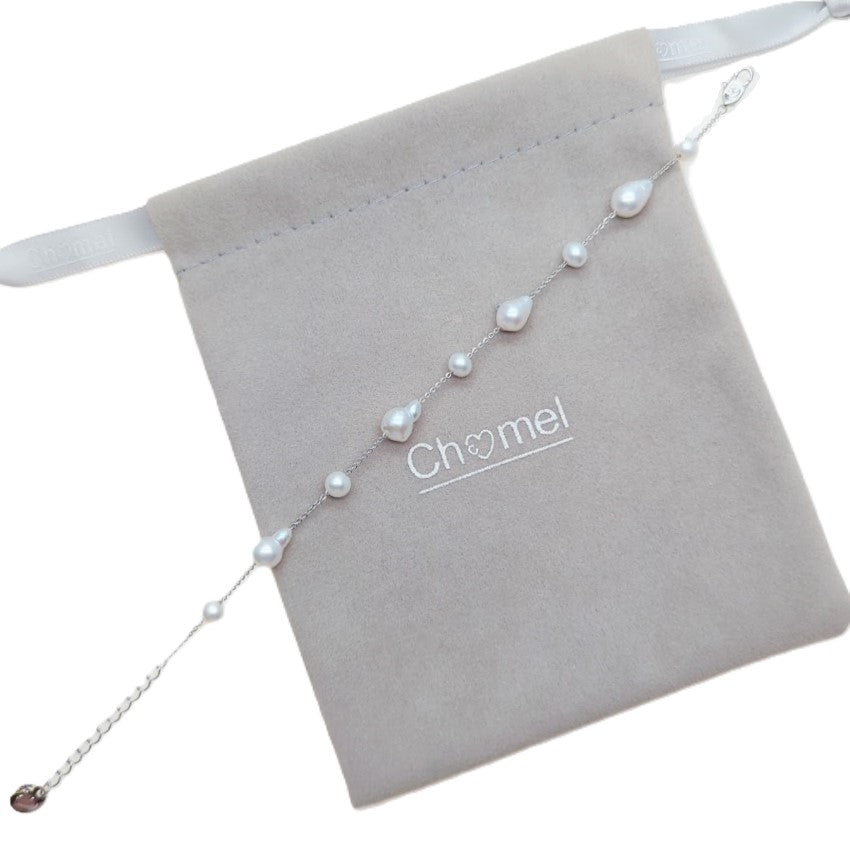 Freshwater Pearl Bracelet with white baroque and roundish pearls on rhodium plated chain with spring clasp displayed on grey pouch
