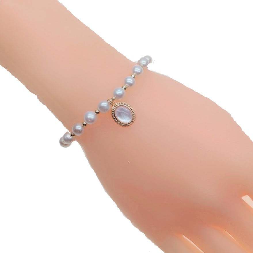 Freshwater pearl bracelet with alternating gold beads and oval simulated moonstone charm on elastic band