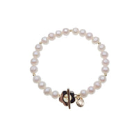 Freshwater pearl bracelet with alternating gold beads and flower-shaped toggle clasp on elastic band
