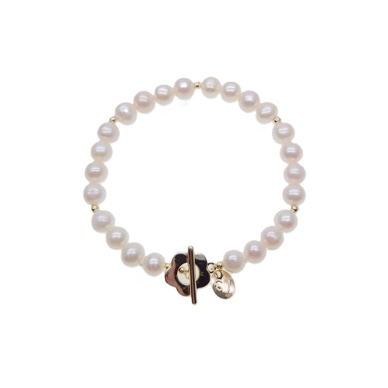 Freshwater pearl bracelet with alternating gold beads and flower-shaped toggle clasp on elastic band