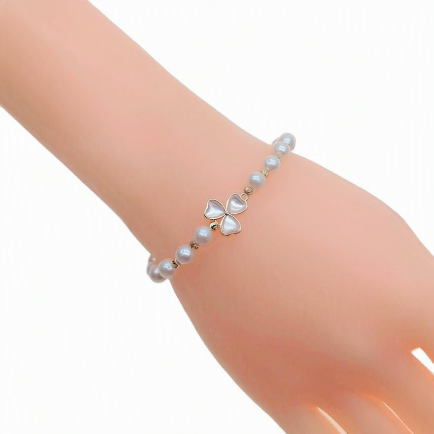 Freshwater pearl bracelet with gold beads and simulated moonstone clover centerpiece