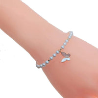 Freshwater pearl bracelet with alternating gold beads and gold butterfly charm on elastic band