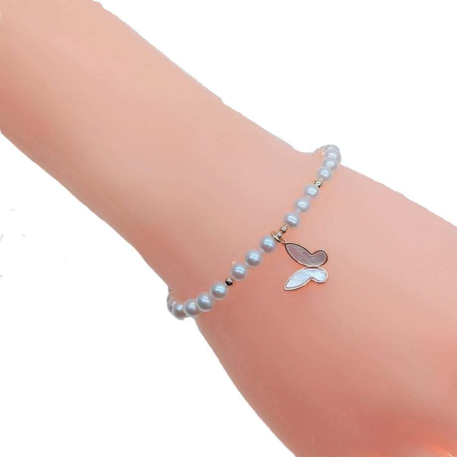 Freshwater pearl bracelet with alternating gold beads and gold butterfly charm on elastic band