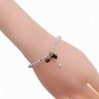 Freshwater pearl bracelet with alternating gold beads and gold heart charm on elastic band