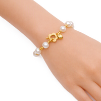 Freshwater Pearl Bracelet with lustrous white 9mm pearls and gold beads, featuring a gold-plated floral toggle clasp.