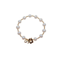 Freshwater Pearl Bracelet featuring 9mm white pearls with small gold beads and a gold-plated toggle clasp