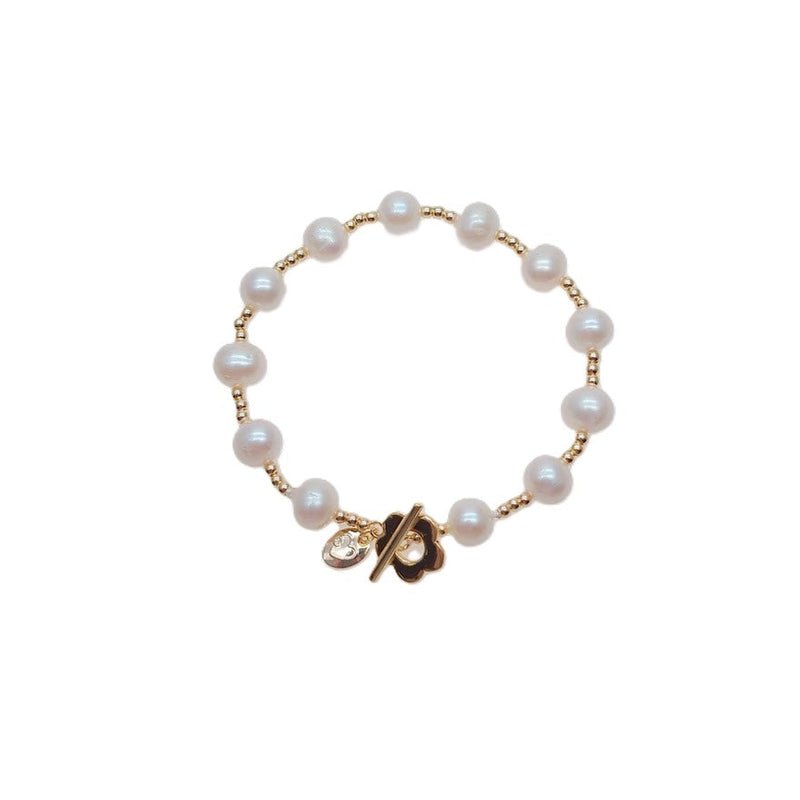 Freshwater Pearl Bracelet featuring 9mm white pearls with small gold beads and a gold-plated toggle clasp