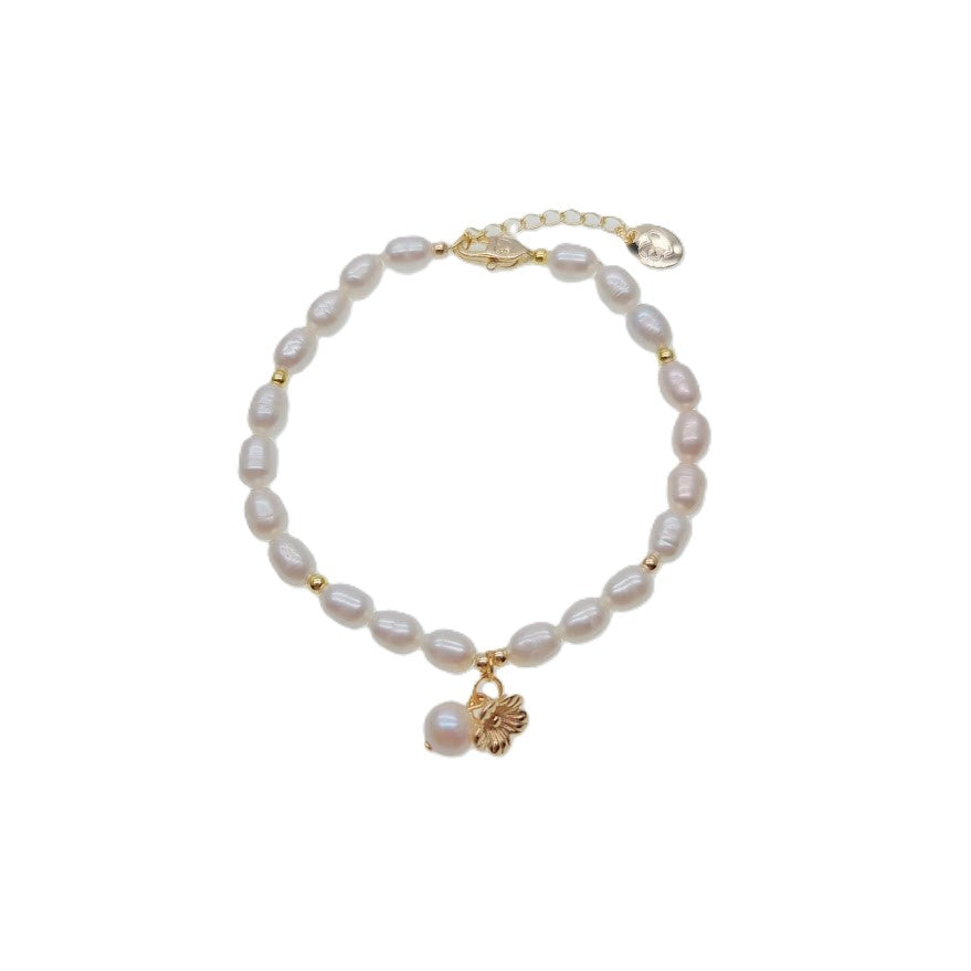 Freshwater pearl bracelet with alternating gold beads and gold flower charm on spring clasp
