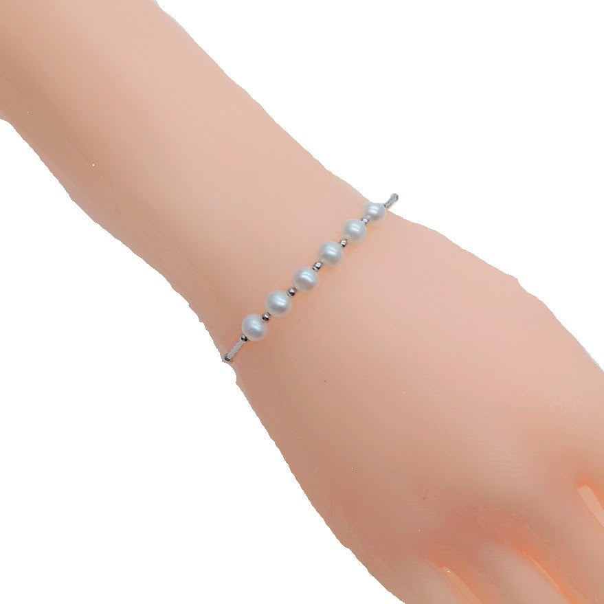 Freshwater Pearl Bracelet featuring small round white pearls with a rhodium-plated chain and a spring clasp closure.