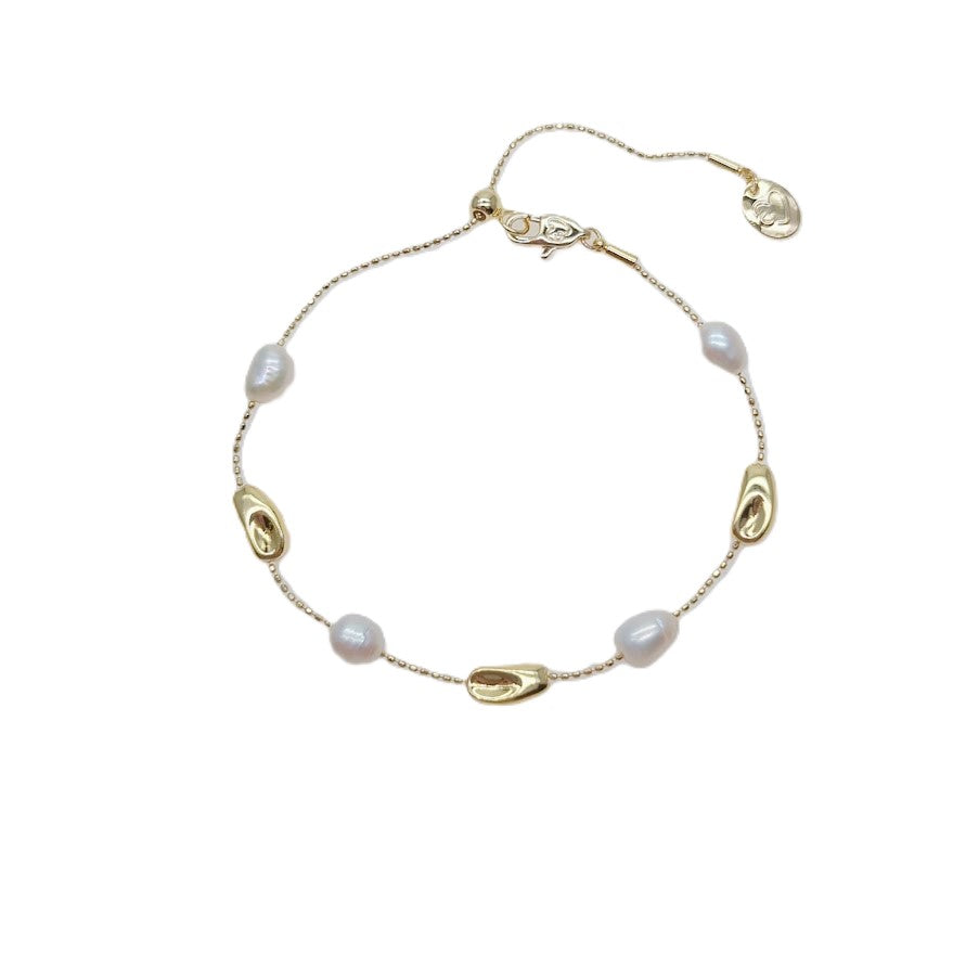 Freshwater Pearl Bracelet featuring white irregular freshwater pearls and gold-plated beads on an adjustable sliding chain design