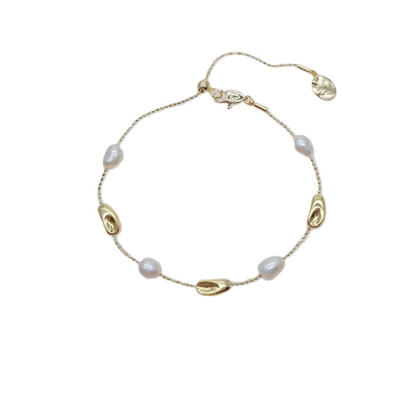 Freshwater Pearl Bracelet featuring white irregular freshwater pearls and gold-plated beads on an adjustable sliding chain design