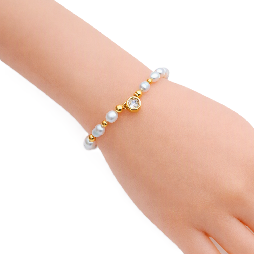 Freshwater Pearl Bracelet with white round pearls, gold beads, and a gold plated round charm with clear stone centerpiece