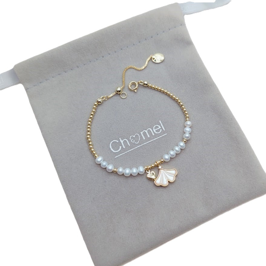 Freshwater Pearl Bracelet featuring 4mm white pearls, gold beads, and gold-plated ginkgo leaf and heart charms on an adjustable chain