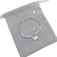 Freshwater Pearl Bracelet featuring 4mm white pearls, gold beads, and gold-plated ginkgo leaf and heart charms on an adjustable chain