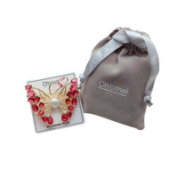 Gold-plated butterfly brooch with cubic zirconia, red stones, and freshwater pearl, elegant mother of pearl design