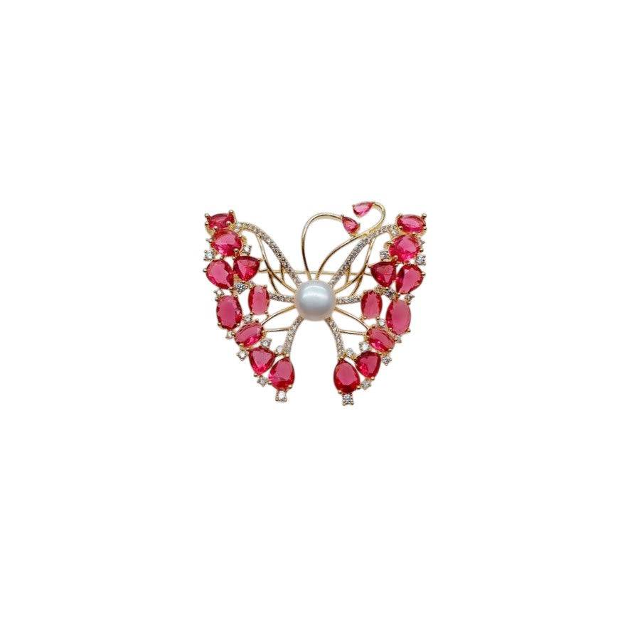 Gold-plated butterfly brooch with cubic zirconia, red stones, and freshwater pearls