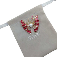 Gold-plated butterfly brooch with cubic zirconia, red stones, and freshwater pearls, butterfly mother of pearl design
