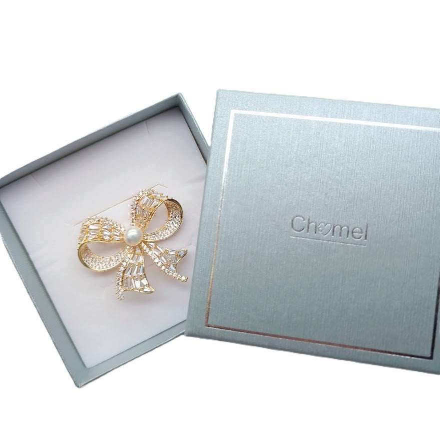 Gold plated ribbon freshwater pearl brooch with cubic zirconia and pin clasp closure