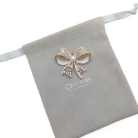 Gold plated ribbon freshwater pearl brooch with cubic zirconia and 7mm pearl centerpiece