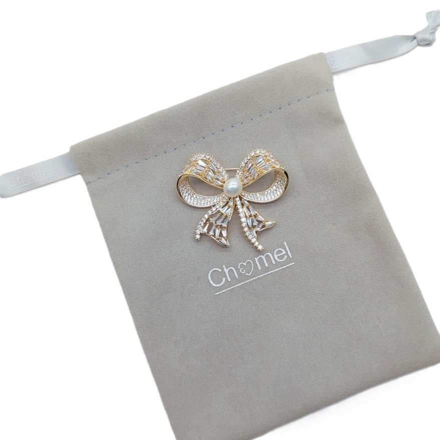 Gold plated ribbon freshwater pearl brooch with cubic zirconia and 7mm pearl centerpiece