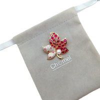 Gold plated flower freshwater pearl brooch with cubic zirconia and red stones, featuring an 8mm button freshwater pearl