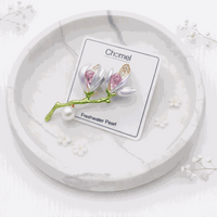Flower Freshwater Pearl Brooch with lilac enamel petals, pink and gold accents, green stem and round white pearl.