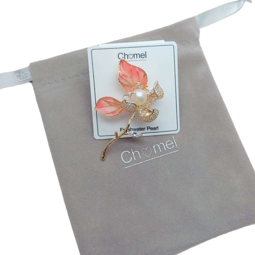 Flower Freshwater Pearl Brooch with coral pink enamel petals, a central pearl, gold-tone stem and sparkling crystal accents.