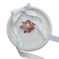Flower Freshwater Pearl Brooch with purple enamel petals, gold-tone detailing, sparkling stones and a central white pearl.