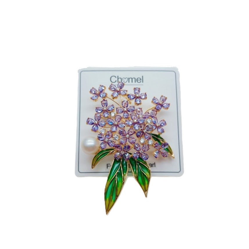 Flower Freshwater Pearl Brooch with purple faceted flower stones, green enamel leaves, and a single white pearl accent.