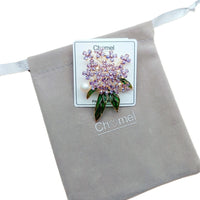 Flower Freshwater Pearl Brooch with gold-tone clustered purple crystal flowers, green enamel leaves and a white pearl accent.