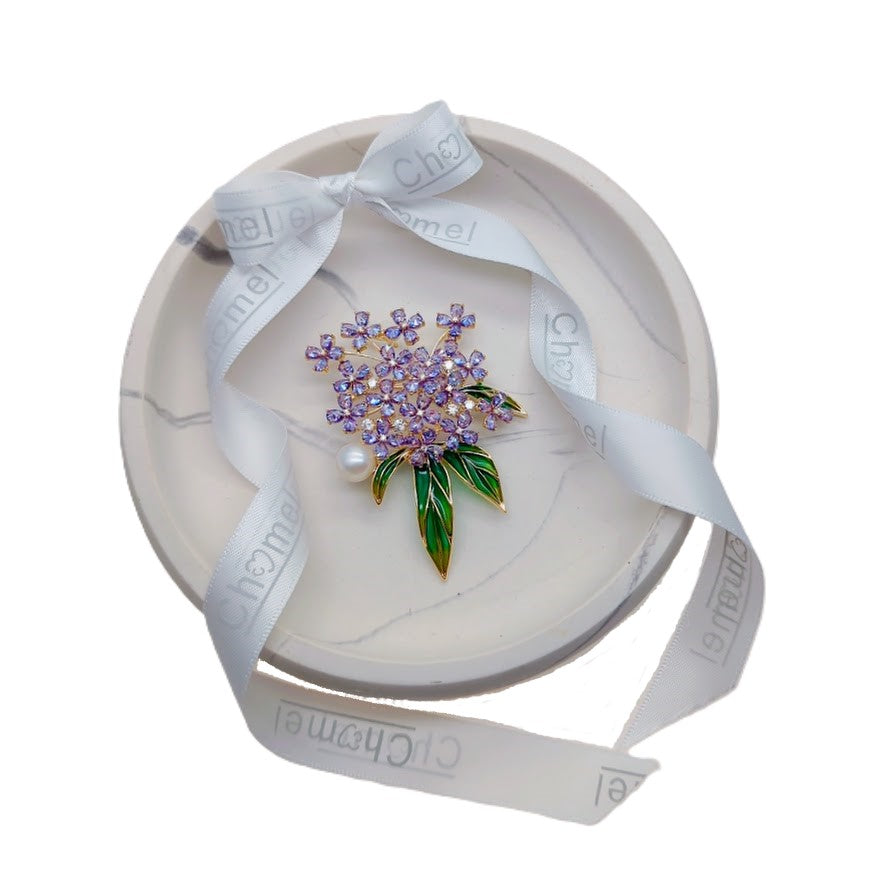 Flower Freshwater Pearl Brooch with purple crystal flowers, green enamel leaves, gold-tone setting and a white pearl accent.