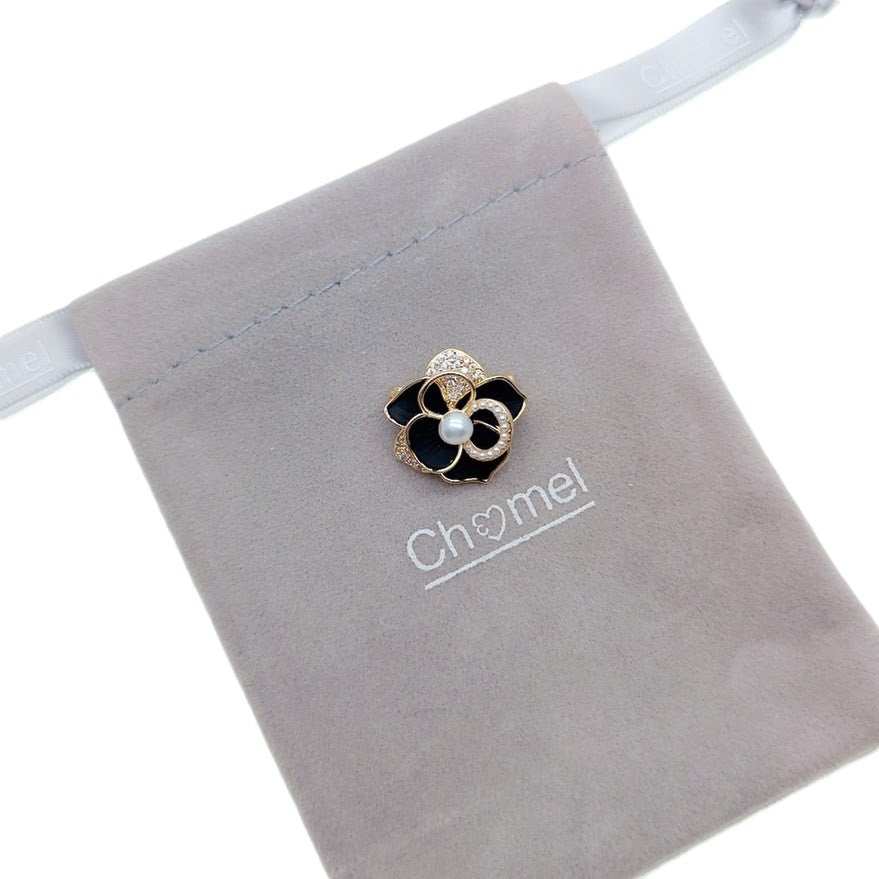 Gold plated flower freshwater pearl brooch with enamel petals and central 4-5mm pearl, 2cm diameter.