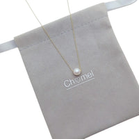 Freshwater Pearl Necklace featuring a single white pearl on a delicate gold-plated chain with an adjustable clasp.