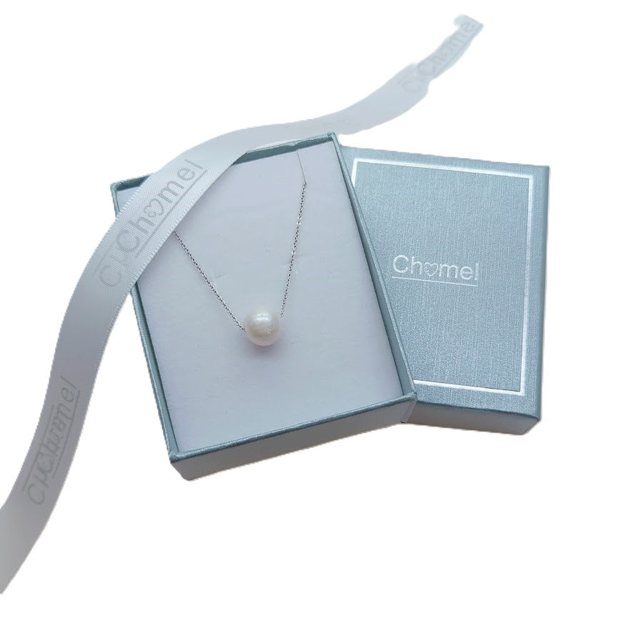 Freshwater Pearl Necklace featuring a single lustrous white pearl on a delicate rhodium plated chain in a blue gift box.