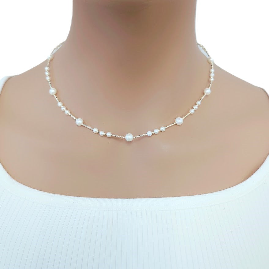 Freshwater Pearl Necklace featuring small white roundish pearls on delicate gold-plated filigree wire choker design