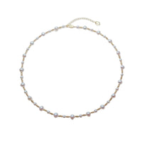 Freshwater Pearl Necklace featuring irregular 5 and 7mm white freshwater pearls alternating with small gold-plated beads on wire choker