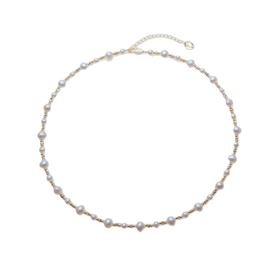 Freshwater Pearl Necklace featuring irregular 5 and 7mm white freshwater pearls alternating with small gold-plated beads on wire choker