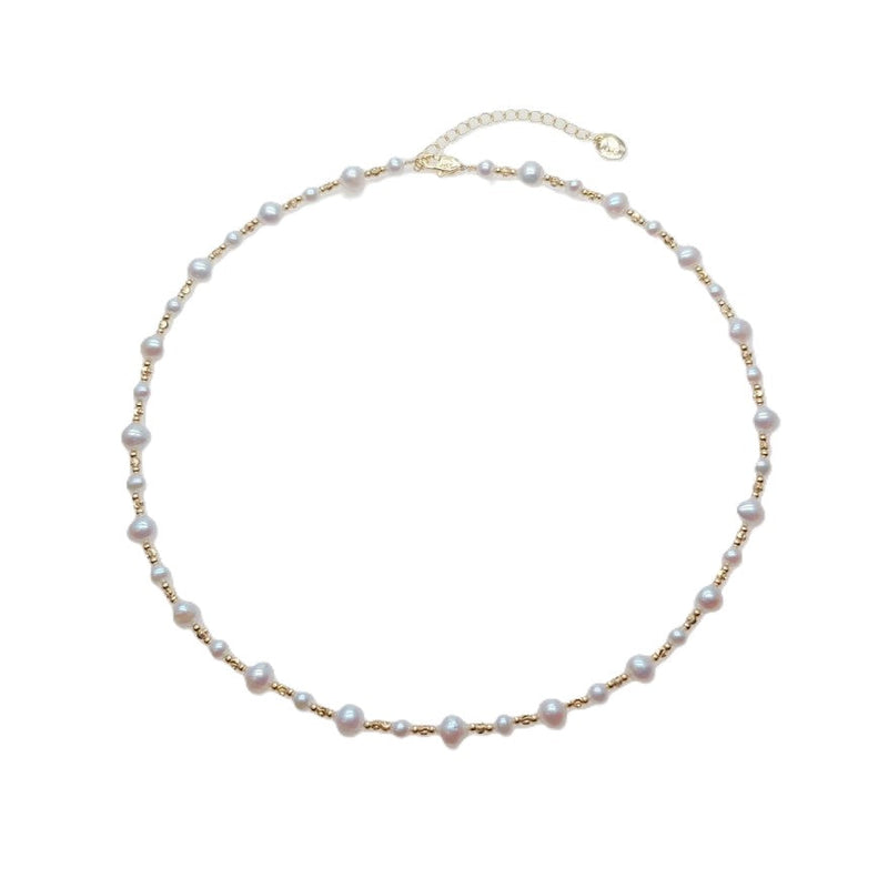 Freshwater Pearl Necklace featuring irregular 5 and 7mm white freshwater pearls alternating with small gold-plated beads on wire choker
