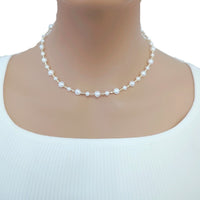 Freshwater Pearl Necklace featuring white round and potato-shaped pearls alternating with small gold-plated beads on delicate wire choker