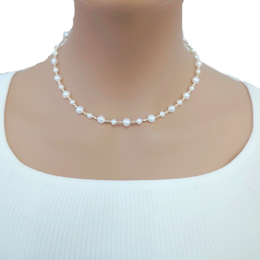 Freshwater Pearl Necklace featuring white round and potato-shaped pearls alternating with small gold-plated beads on delicate wire choker