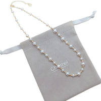 Freshwater Pearl Necklace featuring roundish white pearls alternating with small gold-plated beads on delicate wire with clasp