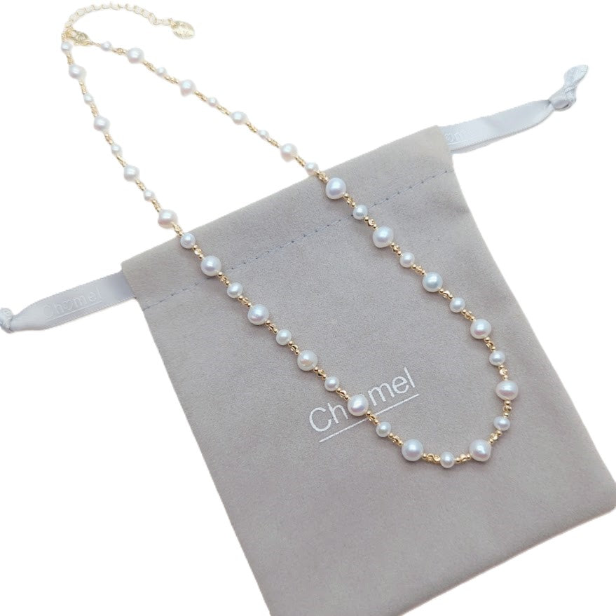 Freshwater Pearl Necklace featuring roundish white pearls alternating with small gold-plated beads on delicate wire with clasp