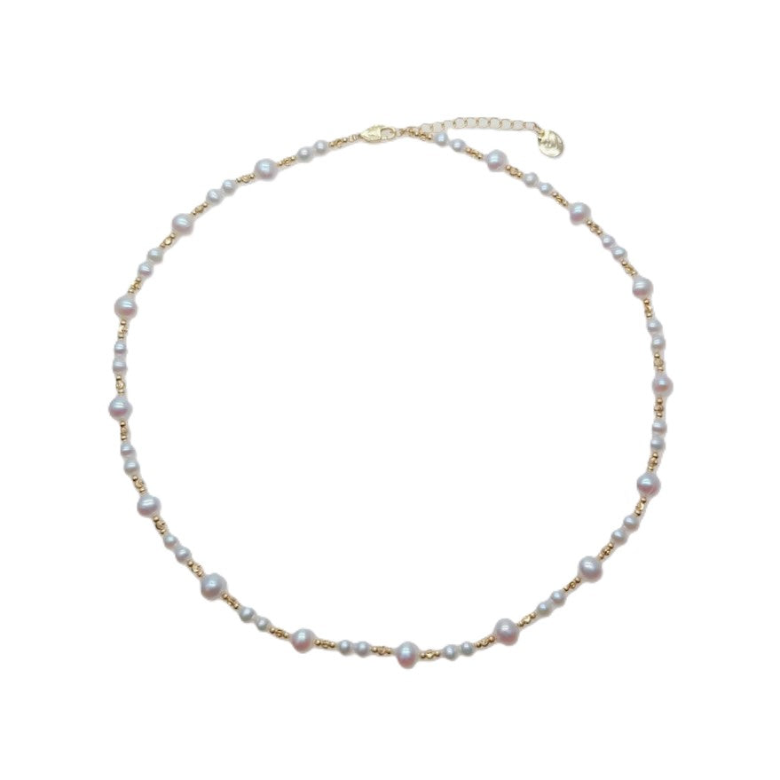Freshwater Pearl Necklace with roundish potato-shaped white pearls and gold-plated beads on a delicate wire choker.